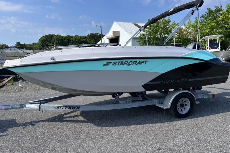 Slide: The Image of 2025 Starcraft SVX 171 OB boat on trailer, parked outdoors. - 10