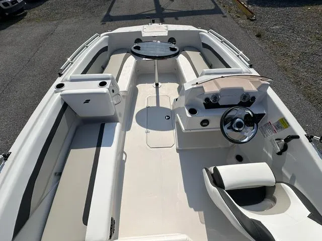 Slide: The Image of 2025 Starcraft SVX 171 OB boat interior with seating and steering console. - 2