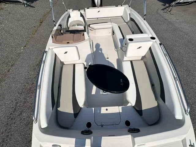 Slide: The Image of 2025 Starcraft SVX 171 OB boat interior with seating and table. - 3