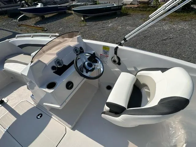 Slide: The Image of 2025 Starcraft SVX 171 OB boat interior with steering wheel and seating. - 4