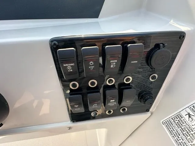 Slide: The Image of Control panel of 2025 Starcraft SVX 171 OB boat with various switches and buttons. - 6