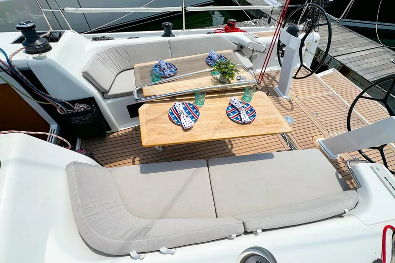 Slide: The Image of Dehler 42c 2021 sailboat cockpit with dining setup and cushioned seating. - 12