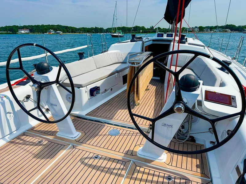 Slide: The Image of 2021 Dehler 42c sailboat cockpit with dual steering wheels and teak decking. - 13