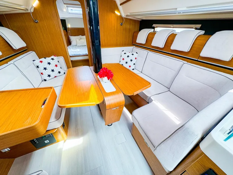 Slide: The Image of Interior of 2021 Dehler 42c sailboat with cozy seating and wooden table. - 20