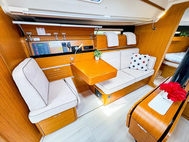 Slide: The Image of Interior of 2021 Dehler 42c sailboat with cozy seating and wooden finishes. - 24