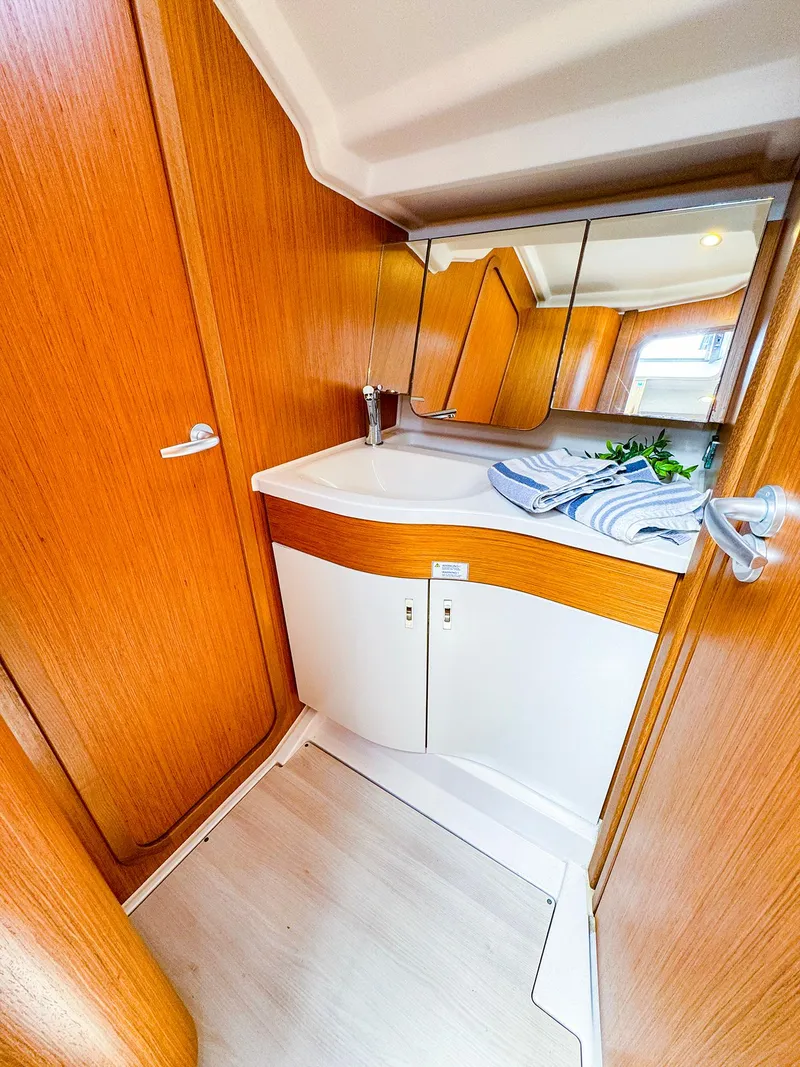 Slide: The Image of Modern bathroom in 2021 Dehler 42c yacht with wooden cabinetry and mirrored storage. - 32