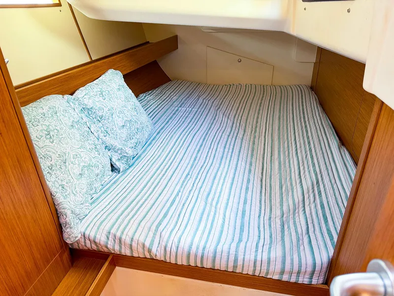 Slide: The Image of Cozy cabin bed in 2021 Dehler 42c sailboat with striped bedding. - 38