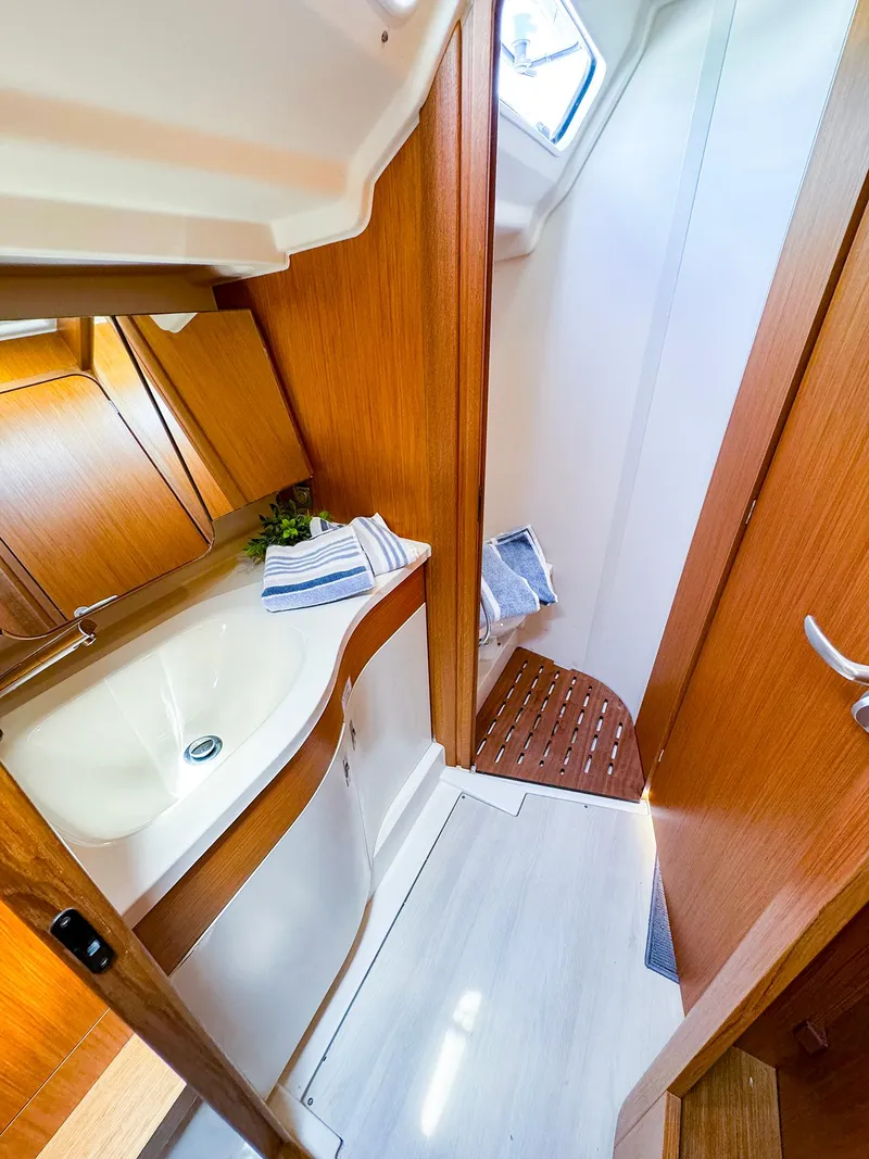 Slide: The Image of Modern bathroom in 2021 Dehler 42c yacht with wooden finishes and white sink. - 40