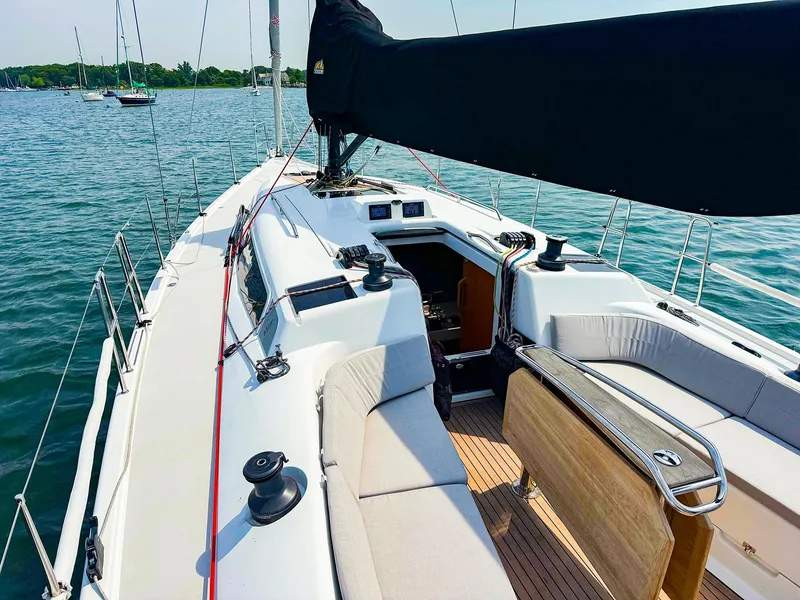 Slide: The Image of 2021 Dehler 42c sailboat with spacious deck and seating area on the water. - 9