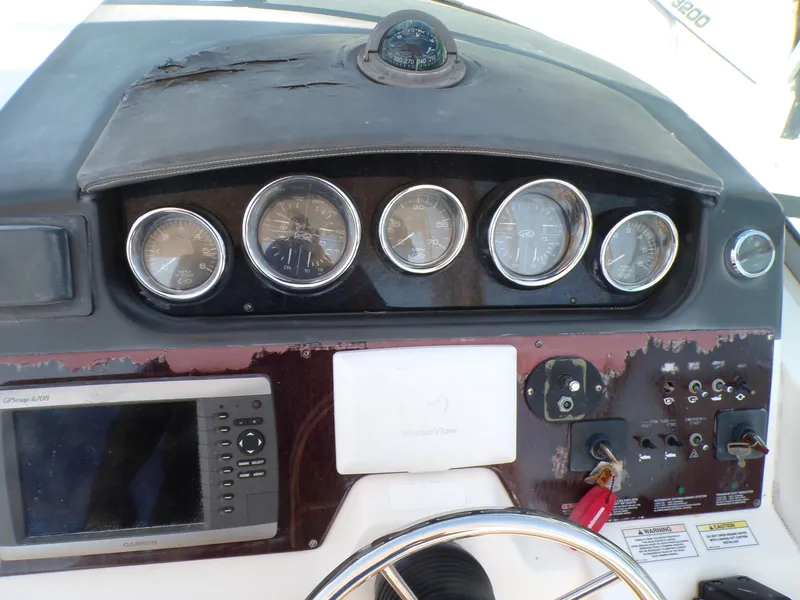 Slide: The Image of Control panel of a 2010 Sea Ray Sundancer boat with gauges and navigation system. - 10