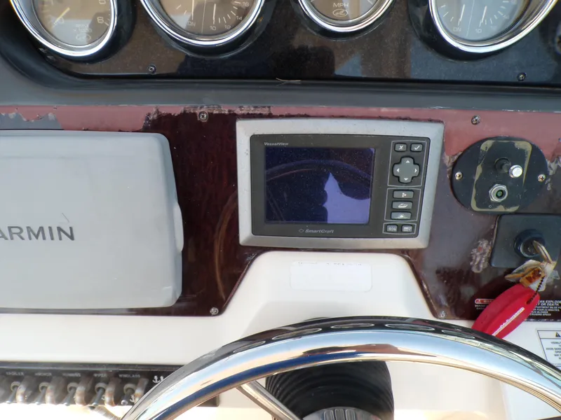 Slide: The Image of Dashboard of a 2010 Sea Ray Sundancer boat with Garmin navigation system. - 11