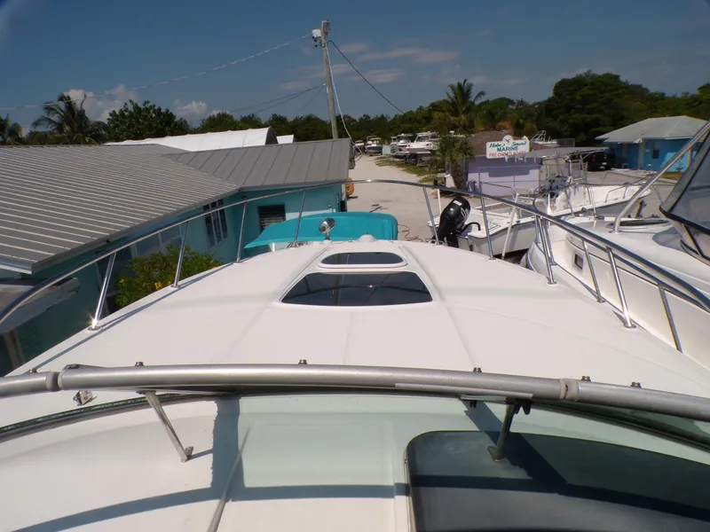 Slide: The Image of 2010 Sea Ray Sundancer yacht docked at a marina with clear skies. - 3