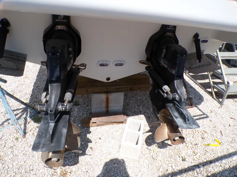 Slide: The Image of 2010 Sea Ray Sundancer boat propellers and outdrives on gravel. - 5