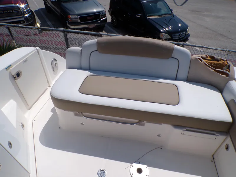 Slide: The Image of 2010 Sea Ray Sundancer boat seating area with beige and white cushions. - 7