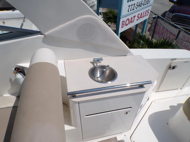 Slide: The Image of 2010 Sea Ray Sundancer boat sink and counter area near Boat Sales sign. - 8