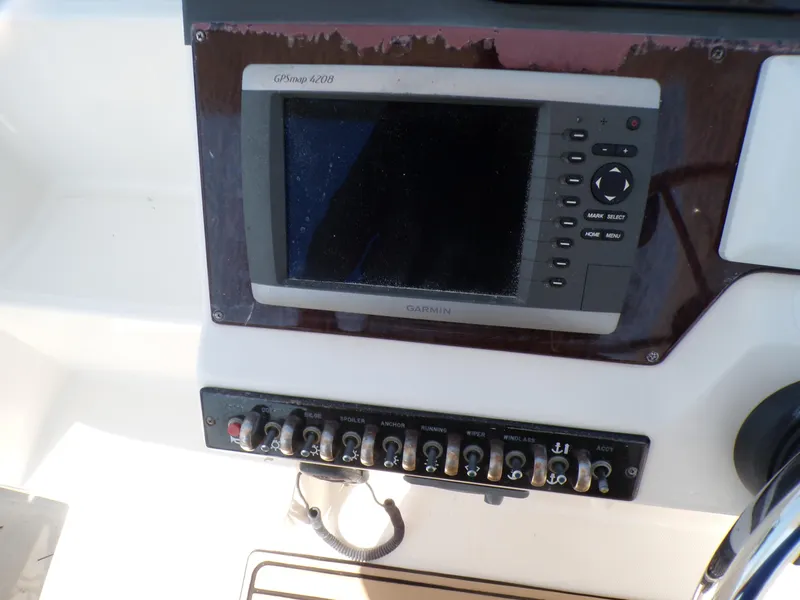 Slide: The Image of Sea Ray Sundancer 2010 boat dashboard with Garmin GPSmap 5208 and control panel. - 9