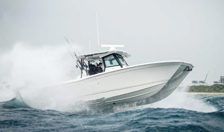 Slide: The Image of 2025 Caymas 30 CT boat navigating rough waters. - 2