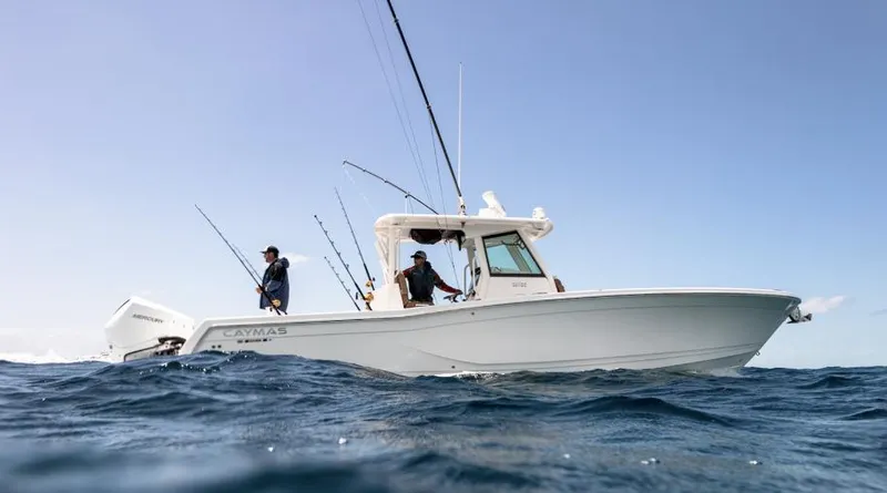 Slide: The Image of 2025 Caymas 341 CC boat with anglers fishing in open water. - 2