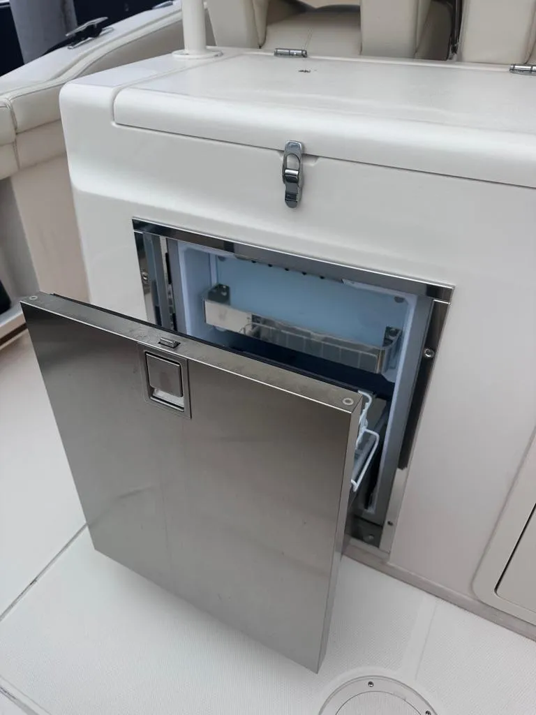 Slide: The Image of Grady-White Canyon 326 2022 boat with an open stainless steel refrigerator. - 16