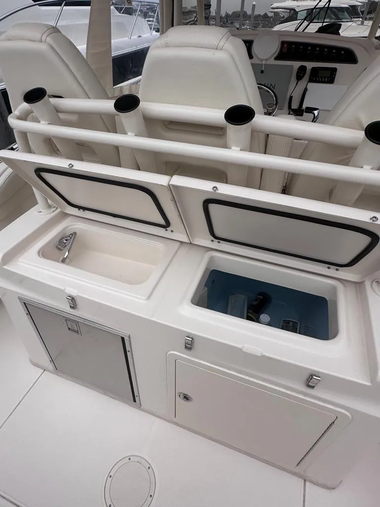 Slide: The Image of 2022 Grady-White Canyon 326 boat interior with storage compartments and seating. - 18