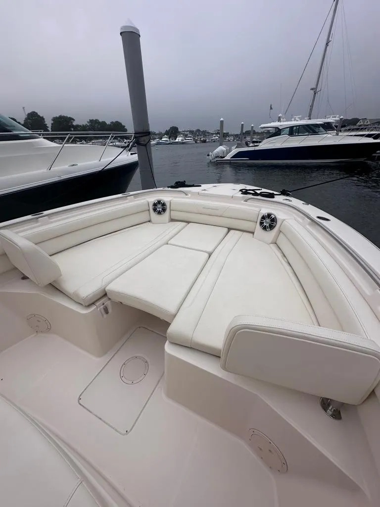 Slide: The Image of 2022 Grady-White Canyon 326 boat with spacious seating at a marina. - 29