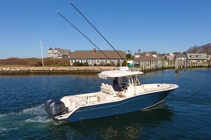Slide: The Image of 2022 Grady-White Canyon 326 boat cruising near coastal homes and docks. - 3