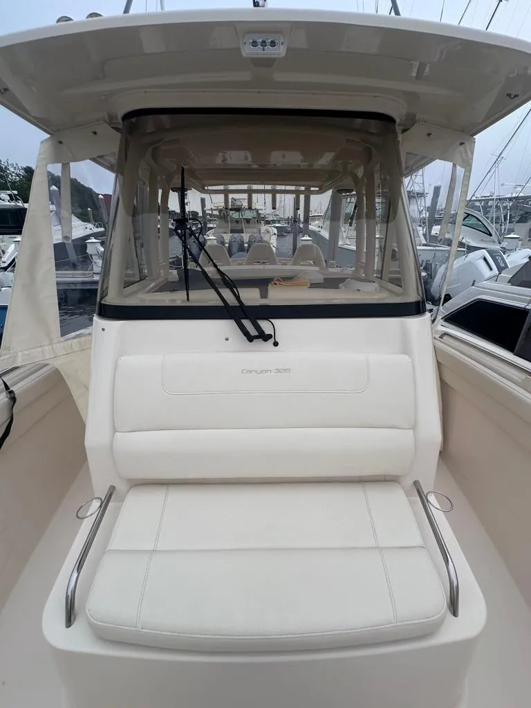Slide: The Image of 2022 Grady-White Canyon 326 boat with cushioned seating and windshield. - 30