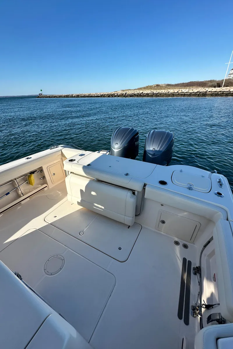 Slide: The Image of 2022 Grady-White Canyon 326 boat with dual engines on calm water. - 37