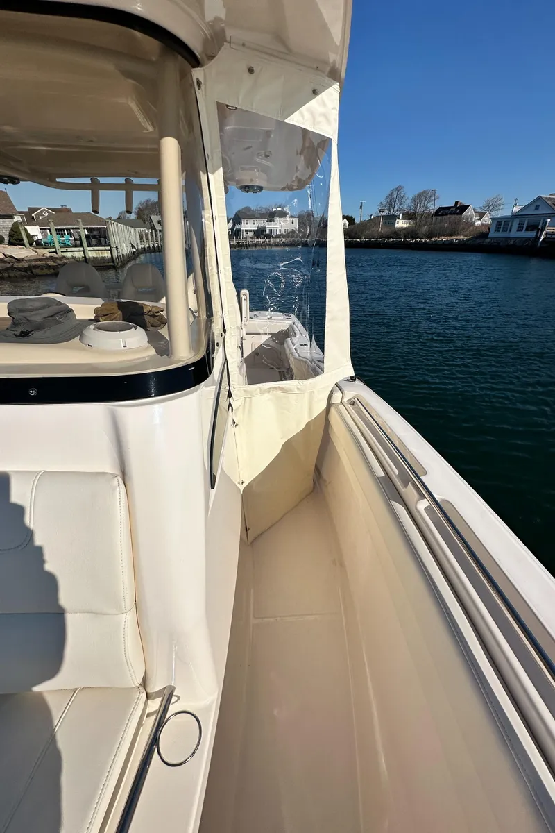 Slide: The Image of 2022 Grady-White Canyon 326 boat, side view, docked near waterfront homes. - 45