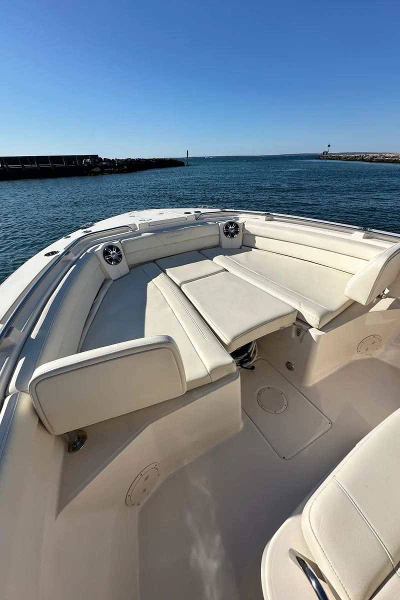 Slide: The Image of 2022 Grady-White Canyon 326 boat with spacious seating, docked by the ocean. - 46