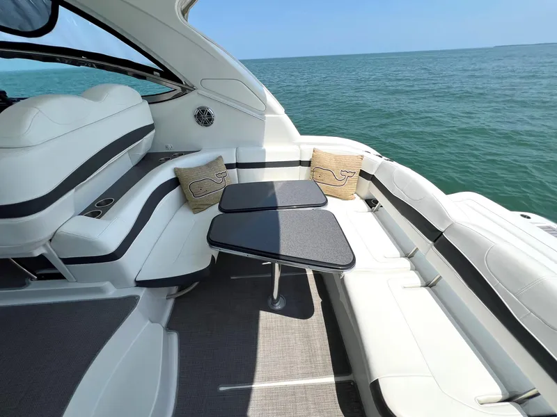 Slide: The Image of 2017 Formula 37 Performance Cruiser interior with ocean view, white seating, and dual tables. - 10
