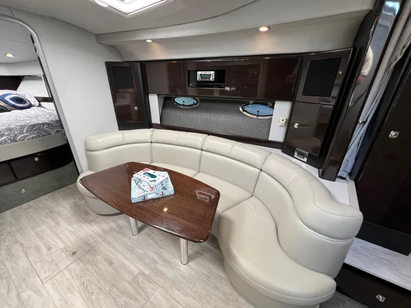 Slide: The Image of 2017 Formula 37 Performance Cruiser interior with curved seating and wooden table. - 22