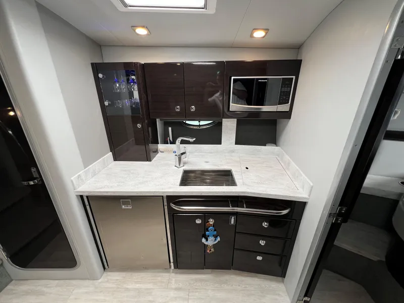 Slide: The Image of 2017 Formula 37 Performance Cruiser kitchen with modern appliances and sleek cabinetry. - 23