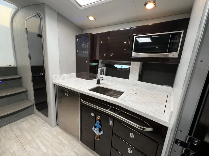 Slide: The Image of Modern kitchen area in 2017 Formula 37 Performance Cruiser with sleek cabinetry and appliances. - 24