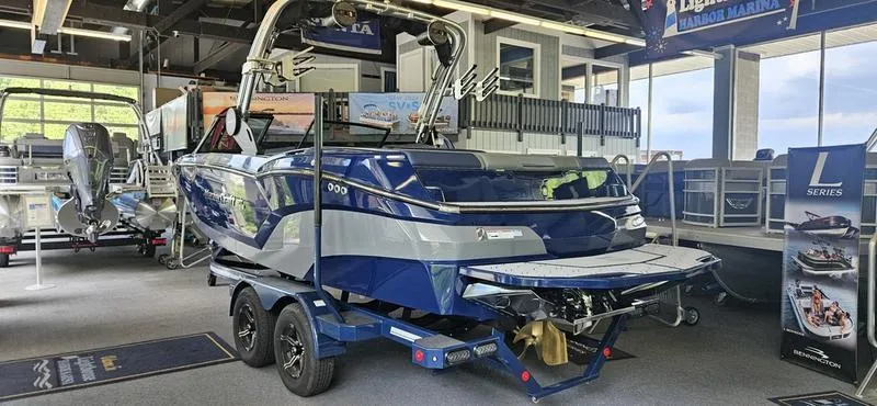 Slide: The Image of 2025 MasterCraft NXT22 boat on display in a showroom. - 1