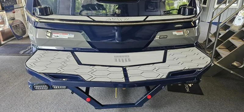 Slide: The Image of 2025 MasterCraft NXT22 boat rear view with swim platform and step ladder. - 4