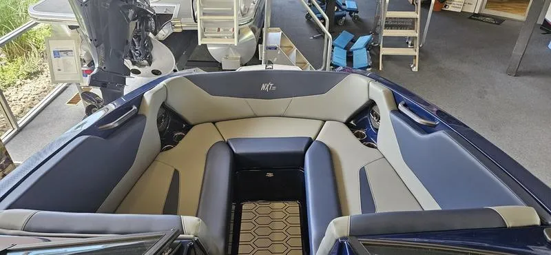Slide: The Image of 2025 MasterCraft NXT22 boat interior with spacious seating and modern design. - 7