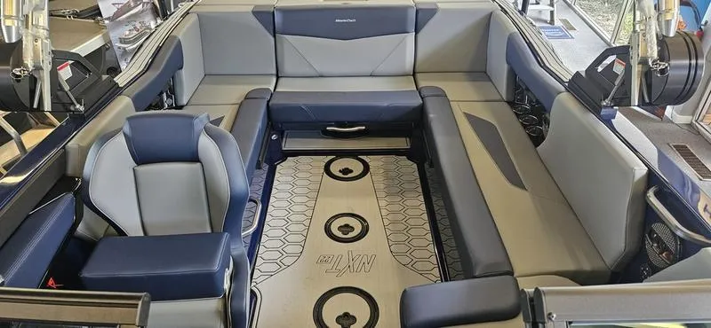 Slide: The Image of 2025 MasterCraft NXT22 boat interior with gray and blue seating. - 8