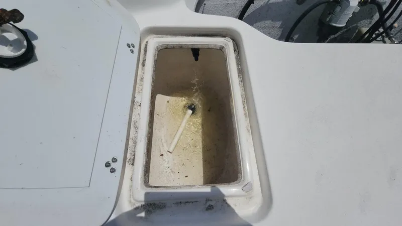 Slide: The Image of 2011 Carolina Skiff 178 DLV boat compartment with open hatch, showing interior details. - 12