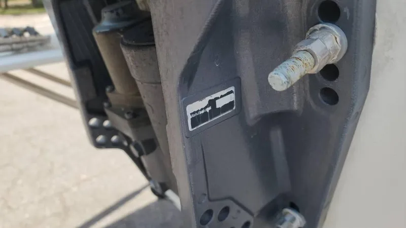 Slide: The Image of Close-up of a 2011 Carolina Skiff 178 DLV boat component with visible bolts and label. - 16