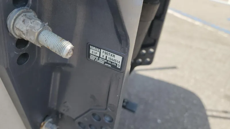 Slide: The Image of Close-up of a Yamaha F90TXR engine part on a 2011 Carolina Skiff 178 DLV. - 18