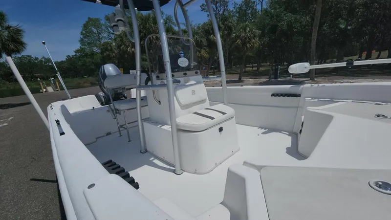 Slide: The Image of 2011 Carolina Skiff 178 DLV boat with center console, parked outdoors. - 21