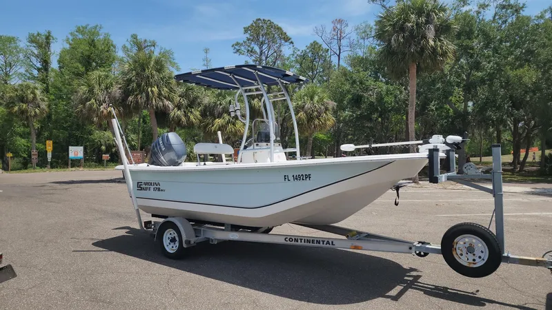Slide: The Image of 2011 Carolina Skiff 178 DLV boat on trailer in sunny parking lot. - 22