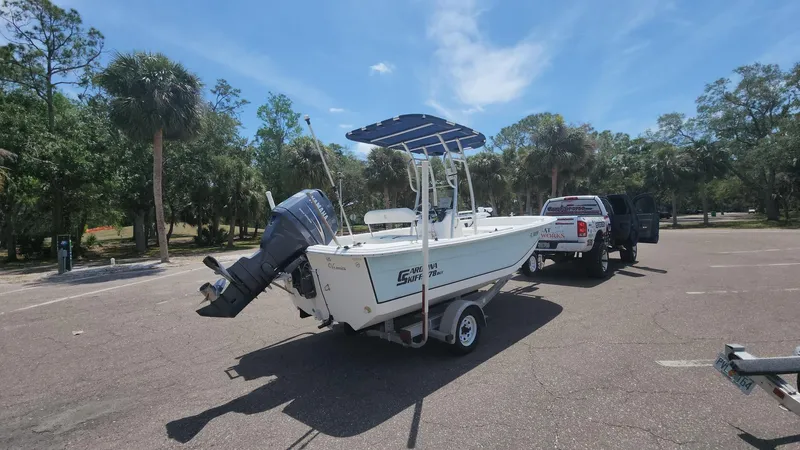 Slide: The Image of 2011 Carolina Skiff 178 DLV boat on trailer in sunny parking lot. - 24