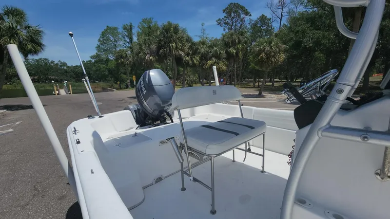 Slide: The Image of 2011 Carolina Skiff 178 DLV boat with outboard motor, parked on a sunny day. - 26