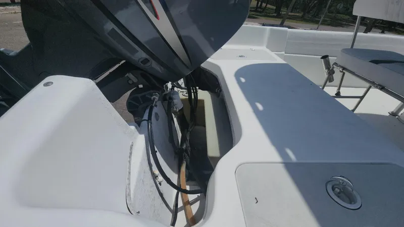 Slide: The Image of 2011 Carolina Skiff 178 DLV boat interior with motor and seating area. - 29