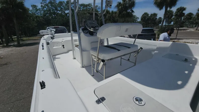 Slide: The Image of 2011 Carolina Skiff 178 DLV boat with seating, parked near palm trees. - 31