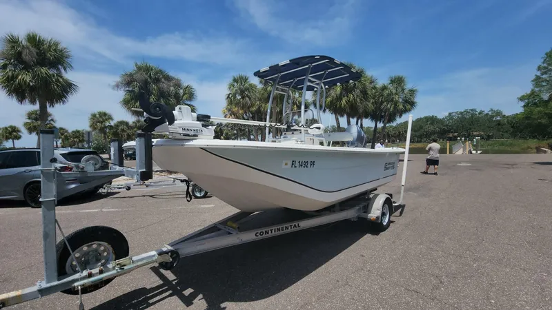 Slide: The Image of 2011 Carolina Skiff 178 DLV boat on trailer in sunny parking lot. - 37
