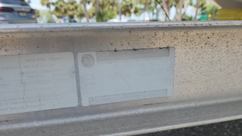 Slide: The Image of 2011 Carolina Skiff 178 DLV boat trailer with identification plate, outdoors. - 39