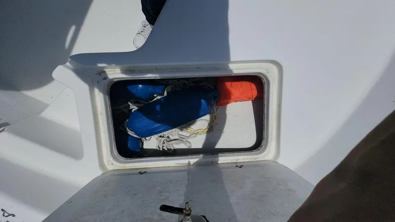 Slide: The Image of Storage compartment on 2011 Carolina Skiff 178 DLV boat with life jackets inside. - 4